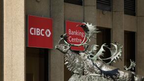 Seal River Crossing statue by sculptor Peter Sawatzky in front of the CIBC logo at Portage and Main, Winnipeg, Manitoba, Canada