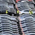A WORKER WALKS AMONGST BRAND NEW JAGUAR CARS AT THE CAR COMPANYS FACTORY AT CASTLE BROMWICH,BIRMINGHAM ,UK.