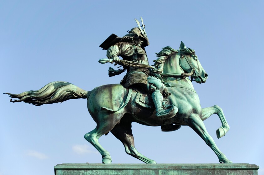 Bronze statue of Masashige Kusunoki, 14th century samurai warrior, on horseback in Kokyogaien Park near Imperial palace, Tokyo.