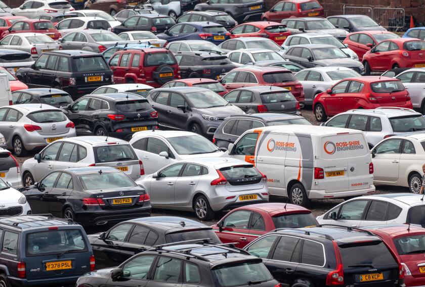 Elevated view of vehicles (Cars and a van) parked in a car park at Ardrossan Harbour, North Ayrshire, Scotland, UK