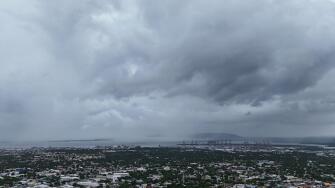 Clouds cover Kingston, Jamaica, ahead of the forecast arrival of Hurricane Melissa on Sunday, Oct. 26, 2025. (AP Photo/Matias Delacroix)