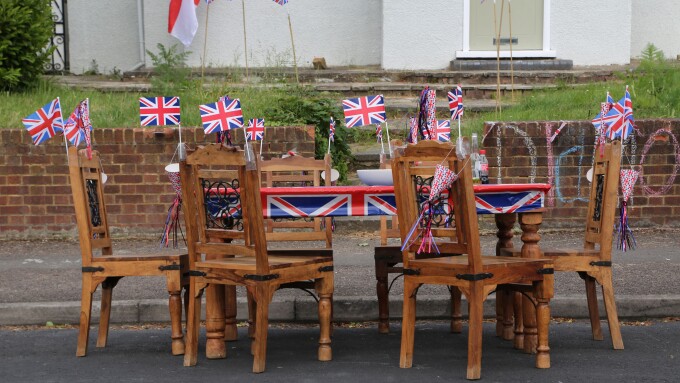 Wooden Table And Chairs Decorated With Union Jack Flags Ready For Street Party Celebrating The Queen's Diamond Jubilee