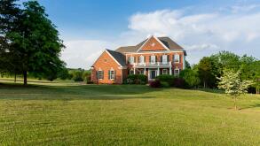 Detached house USA - Front of large single American family home with large garden lawn on a warm sunny summer day