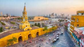 Cartagena, Colombia - February 21st, 2014 - Horsedrawn carriages and haukers wait for tourists and restaurant goers in the Plaza