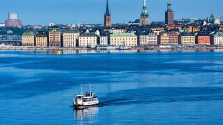 Early morning view of Stockholm waterfront building on Stadsholmen island with Stockholm ferry in foreground, Stockholm, Sweden, Northern Europe