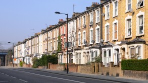 Long row of old three storey terraced flats & apartments without parked cars in Hackney London close to town centre & train station England UK