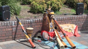 Aborigine busker playing didgeridoo entertains at Circular Quay, The Rocks, Sydney, New South Wales, NSW, Australia, Australasia