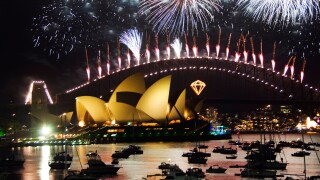 Australia, New South Wales, Sydney. Opera House and Coathanger Bridge with boats in Sydney Harbour - 2006 New Years Eve.