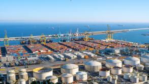 BARCELONA, SPAIN - February 02, 2022: The commercial harbour of Barcelona with containers, cranes and storage tanks
