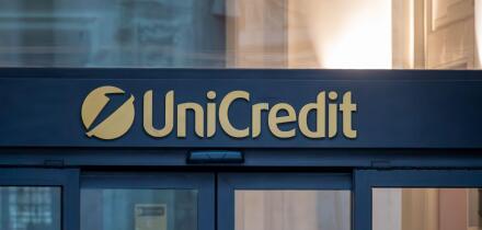 Sign and logo at the entrance of a branch of Unicredit, an Italian multinational banking group headquartered in Milan