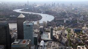 aerial view of Canary Wharf, Docklands & River Thames towards the central London skyline, UK