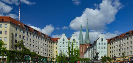 A beautiful shot of a neighborhood of old houses against blue sky in bright sunlight in Berlin, Germany.
