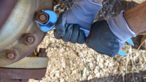 Hands of a workman tighten a bolt.