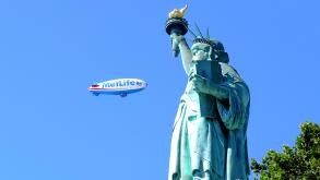 metlife blimp at the statue of liberty new york usa, The airship flies past.