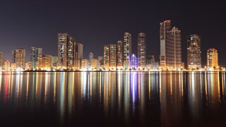 Skyline of Sharjah City at night, United Arab Emirates
