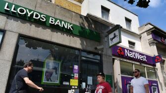 People walk past the branches of NatWest and Lloyds banks in Notting Hill London