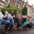 Limbo dance with a hose pipe, during a street party, Bristol.