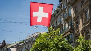 Swiss flag flying in streets of Zurich, Switzerland