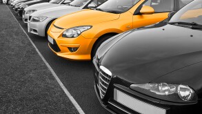 Row of used cars for sale in row with one in colour, great concept for choice of perfect vehicle to buy.