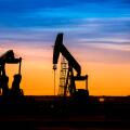 Silhouette of Oil pumps at oil field with nice sunset sky background