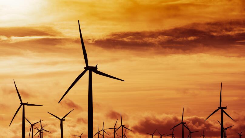 View of wind turbines at sunset at Blacklaw Wind Farm in Scotland, UK