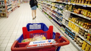 A woman shopping for food in the aisle of a Carrefour French supermarket, France Europe