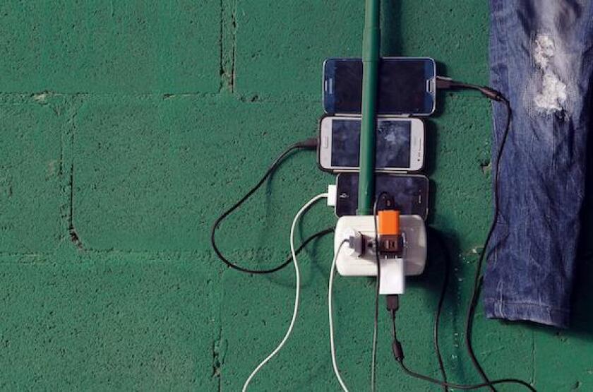 Cuban migrants charge their phones at a temporary shelter in a school in the town of La Cruz, Costa Rica, near the border with Nicaragua, November 17, 2015. More than a thousand Cuban migrants hoping to make it to the United States were stranded in the bo