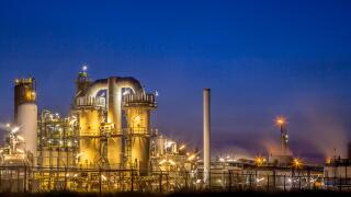 Landscape of a heavy Chemical Industrial plant with mazework of pipes in twilight night scene