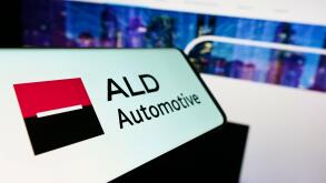 Smartphone with logo of French company TEMSYS S.A. (ALD Automotive) on screen in front of business website. Focus on center-left of phone display.