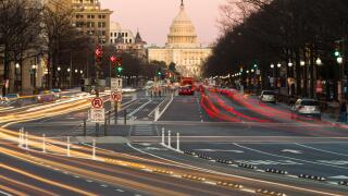 Traffic creates light trails and motion blurs leading to the US Capitol Building on Pennsylvania Avenue in Washington, DC.