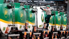 BP tankers lined up for inspecton with BP employee checking them over.. Image shot 2002. Exact date unknown.