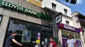 People walk past the branches of NatWest and Lloyds banks in Notting Hill London