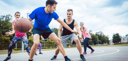 Group of friends are playing basketball outdoors