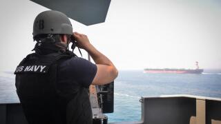 STRAIT OF HORMUZ (July 23, 2017) U.S. Navy Gunner's Mate 3rd Class Jalen Delgado, from Boston, observes passing ships aboard the aircraft carrier USS Nimitz (CVN 68), July 23, 2017, in the Strait of Hormuz. Nimitz is deployed in the U.S. 5th Fleet area of