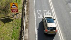 Car braking at warning to slow down on UK road