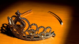 A broken tiara in a rectangular spotlight.