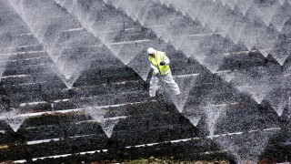 A sewage treatment operator carries out essential cleaning and  maintainance work