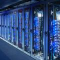 Network cabinets with server racks in a data center. Digital Composite (DC)