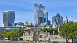 Riverside busy with tourists at Tower of London & view of 2019 London city skyline cityscape with landmark skyscrapers business buildings  England UK