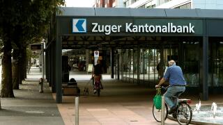 People cycle in front of the headquarters of Zuger Kantonalbank bank in Zug, Switzerland August 30, 2016.  REUTERS/Arnd Wiegmann