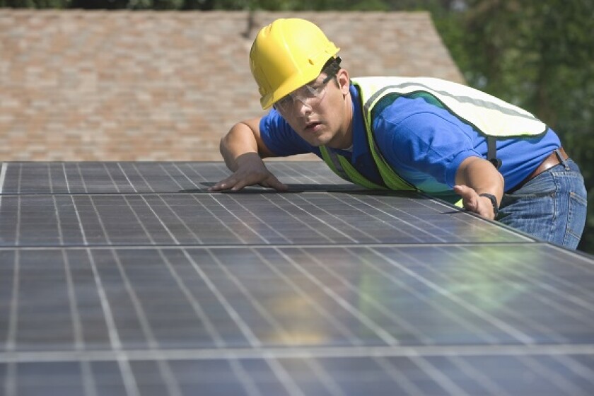 Installing solar panel rooftop from Adobe 9Jul20 575x375