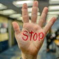 Harassment at work, woman sad angry terrified scared afraid, man, stop no, pressure unhappy male abuse touch hand, flirting bullying uncomfortable job.