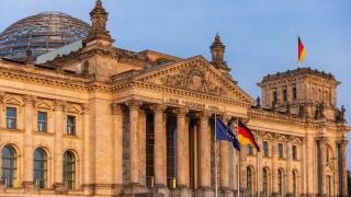 German Parliament the Bundestag in the Reichstag Building. Text says: To the German Population German Parliament the Bundestag in the Reichstag Buildi