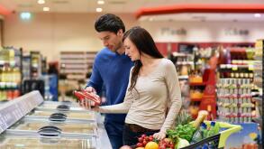 young lucky couple shopping for fresh food in the supermarket - lifestyle