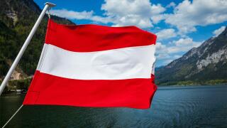 Austrian flag agains mountain lake and Austria alps background