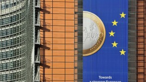 Banner about the euro hanging from building of the European Commission, executive body of European Union in Brussels, Belgium