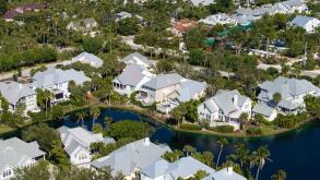 View from above of waterfront neighborhood in Florida with suburban houses. Development of US premium housing