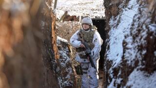 A service member of the Ukrainian armed forces walks in a trench at combat positions near the line of separation from Russian-backed rebels outside the settlement of Zaitseve in the Donetsk region, Ukraine February 5, 2022. REUTERS/Oleksandr Klymenko