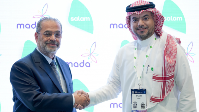 From left: Adel Louis, VP of carrier relations and business development at Mada shakes hands with Abdullah Alrufaidi, wholesale sales director at Salam