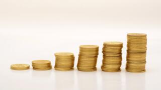 Stack of Golden Coins on White background with reflection.